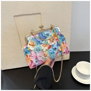 Detailed view of 3D butterfly floral embroidery on a shell-shaped chain crossbody bag