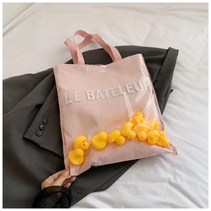 Pink canvas tote bag with transparent PVC layer and yellow rubber ducks detail