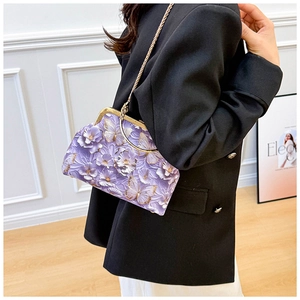 Detail view of 3D purple floral embroidery and golden butterfly on the shell bag