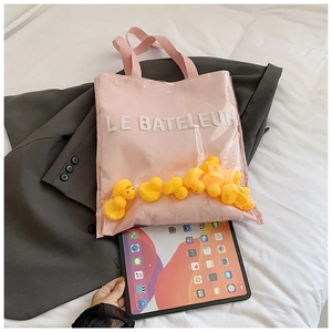 Pink canvas tote bag with transparent PVC layer and yellow duck dolls inside