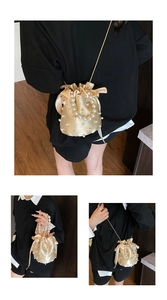 Detailed views of champagne satin bucket bag with pearl accents and drawstring closure