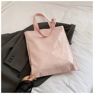 Detail of clear PVC tote with pink canvas interior and sturdy woven handle straps