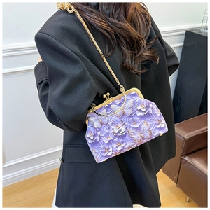 Detail of purple butterfly embroidery and 3D floral relief on the chain shell bag