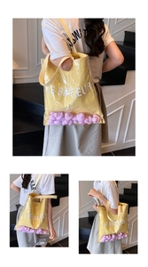 Detail of transparent PVC tote featuring yellow canvas lining and purple duck decorations