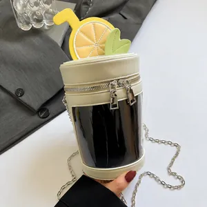 Close-up of lemon tea cylinder bag with top slice detail and metal chain strap