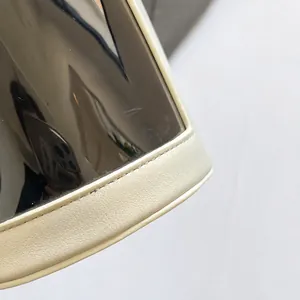Detail shot of the two-tone contrast stitching and premium lychee texture leather on the bag