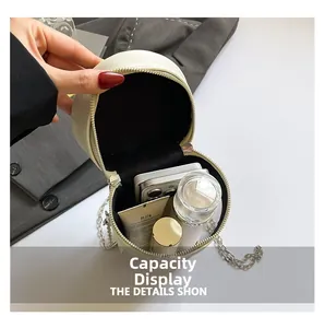 Internal capacity of the beige round lemon tea shaped bag with chain strap detail