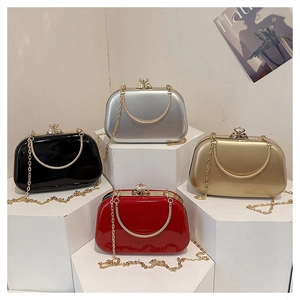 Detail of glossy evening clutch bags in black, silver, gold and red with crystal clasps