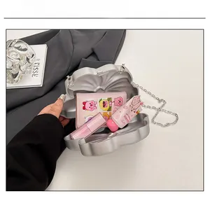 Silver shell-shaped clutch capacity show with small essentials like lipstick and wallet