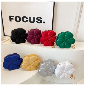 Detailed macro view of 3D floral evening clutch bags in various elegant colors