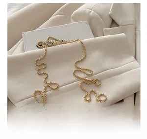 Detail view of the pink heart acrylic bag featuring a glittery finish and metal chain strap