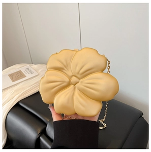 Close-up of golden flower mini chain bag with matte finish for evening and party wear