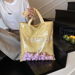 Transparent yellow jelly bucket bag with cute duck deco and Le Bateleur lettering