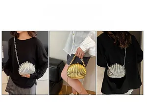 Detail of acrylic shell evening bag with beaded handle and metal chain in gold and silver