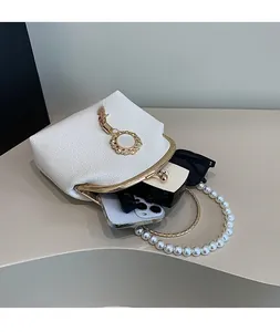 Internal view of a pearl handbag showing storage for phone, lipstick, and sunglasses