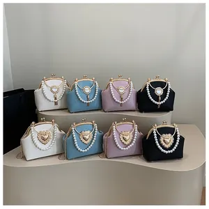 Close-up of pearl handles and vintage metal clasps on textured leather handbags