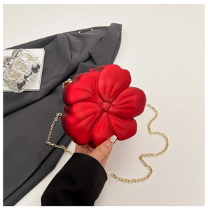 Detailed view of 3D red flower-shaped mini acrylic bag with elegant gold chain strap