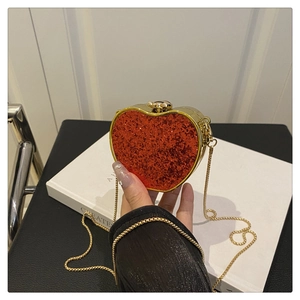 Detail of red sequin heart evening bag with gold metal frame and snap closure