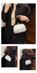 Detail of silver evening clutch bag with gold handle and chain strap on black shirt
