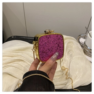 Detail of purple sequin mini box bag featuring gold metal frame and chain strap