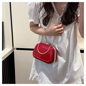 Red glossy clutch bag with gold chain strap and metallic frame for evening wear