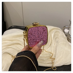 Detail of pink glitter acrylic box bag with gold metal frame and chain strap