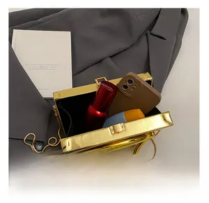Internal capacity of gold acrylic box clutch with ring handle and metal chain strap