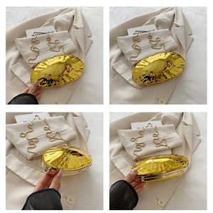 Close-up of golden irregular wavy texture on luxury acrylic evening clutch bag with chain