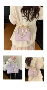 Detail of pink pearl handbag with gold chain strap and elegant kiss-lock shell design