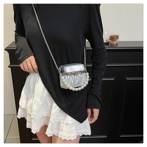 Close-up of the silver quilted texture bag with faux pearl handle and metal chain strap