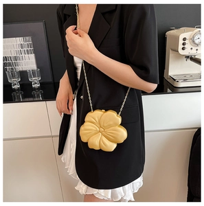 Golden camellia flower shaped hard shell clutch bag with a delicate metallic chain strap