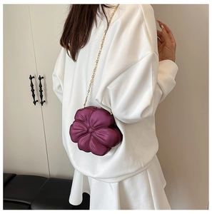 Close-up of a deep purple 3D flower-shaped mini bag with a slim gold chain strap