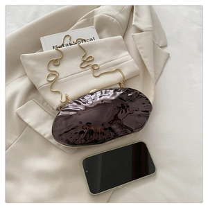 Macro shot of ripple textured acrylic clutch bag interior showing smartphone capacity