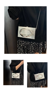 Macro view of silver acrylic box bag featuring metallic ring buckle and sleek chain strap