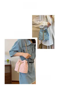 Detail of pink and blue frayed denim bucket bags with gold chains and pearl drawstring