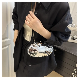 Detail of silver liquid metal texture shoulder bag with refined thin chain and metallic finish