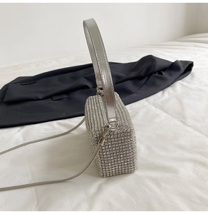 Close-up of the silver rhinestone handbag showing crystal texture and snake chain strap