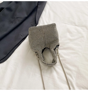 Detail of silver rhinestone bucket bag showing intricate crystal mesh and chain strap