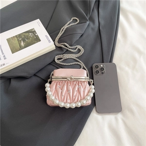 Mini pink pleated pearl handbag with silver crossbody chain and quilted diamond pattern