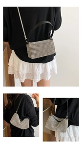 Detail of silver rhinestone shoulder bag showing detachable metal chain and leather handle