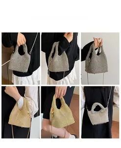 Detail view of rhinestone bucket bags showing hand-held and crossbody chain strap styles