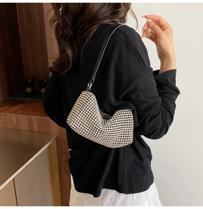 Silver rhinestone shoulder bag with black leather strap worn by model in a minimal setting