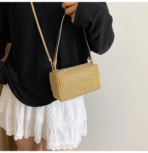 Detailed shot of a gold rhinestone crossbody bag worn with a casual chic outfit