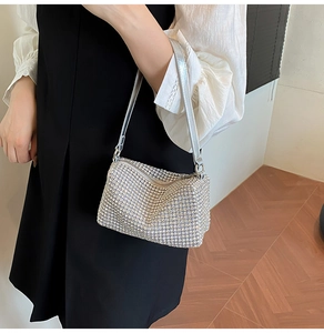 Detailed close-up of sparkling silver rhinestone surface on this elegant shoulder bag