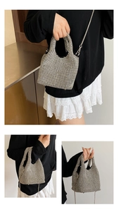 Detail showing sparkling silver rhinestone bucket bag with chain strap and handle