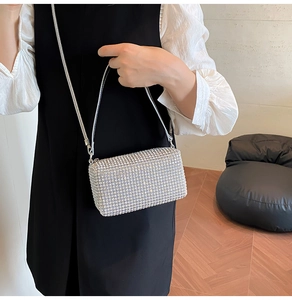 Detail of silver rhinestone crossbody bag with elegant chain strap and sparkling finish