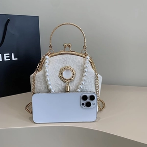 Elegant white pearl handbag with gold handle and phone for size reference