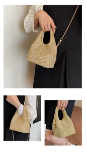 Close-up of golden rhinestone bucket bag with shiny chain strap and sparkling crystal handle