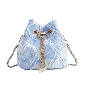 Light blue denim bucket bag with diamond quilting, frayed edges and pearl drawstring