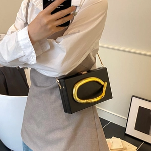 Modern black acrylic box clutch with gold oval handle and chain strap for women